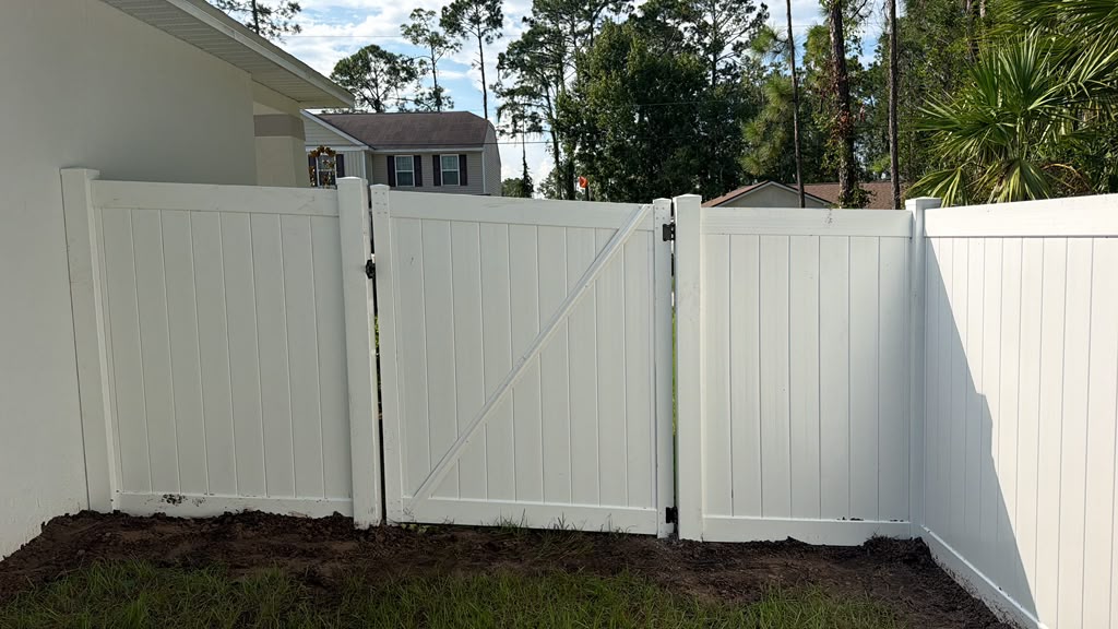 White vinyl gate beside a home